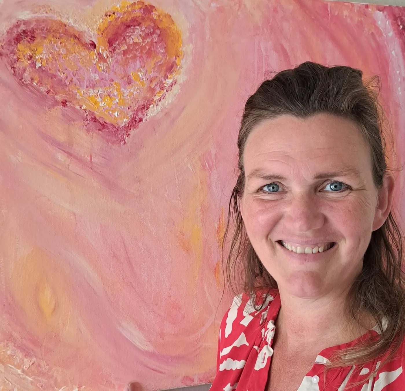 Edith Dijk voor een van haar roze schilderijen